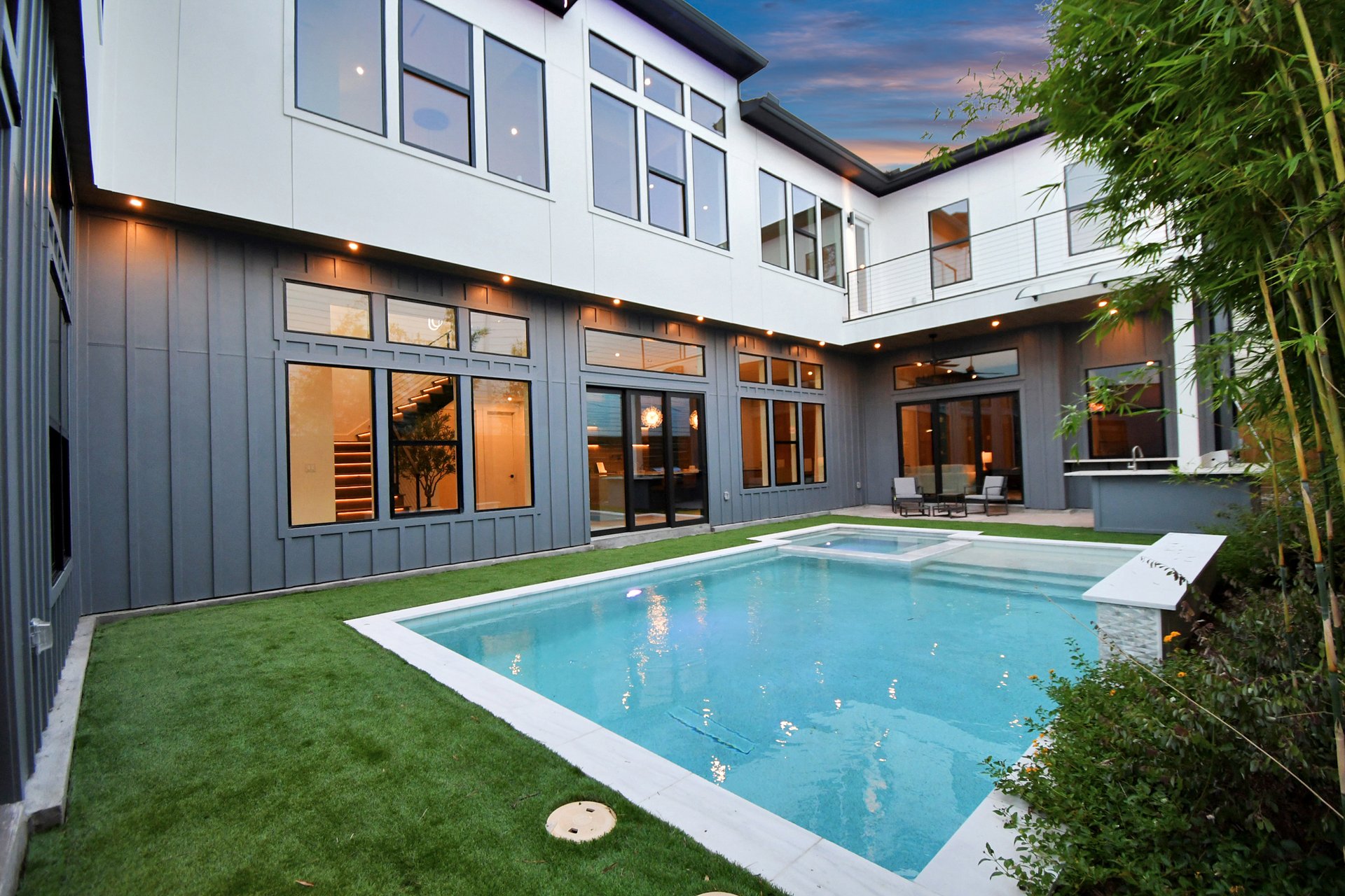 Private interior courtyard with pool and spa at twilight