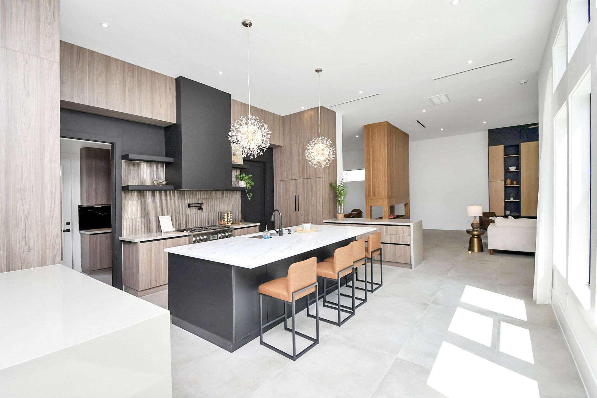 Chef-grade kitchen with marble waterfall island and starburst pendants