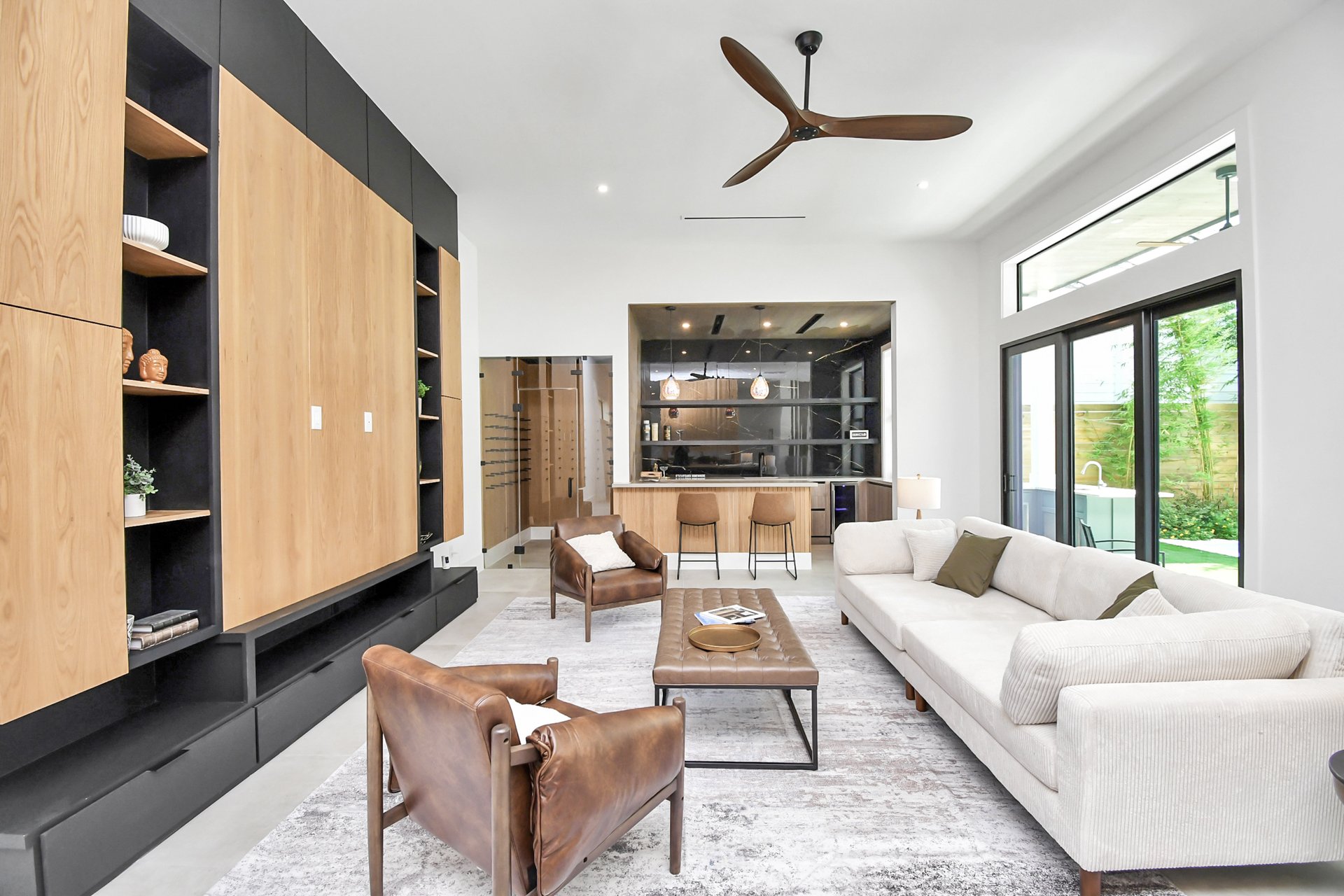 Main living room with full bar and wine cellar visible