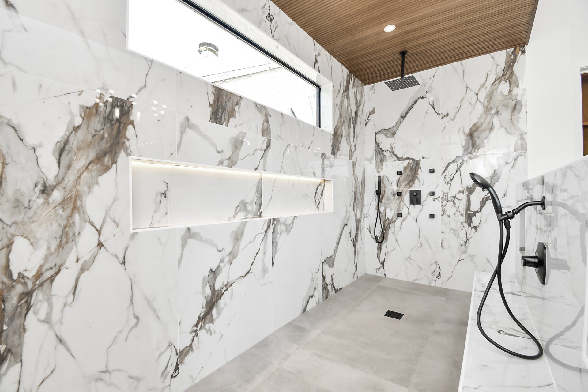 Walk-in shower with calacatta marble